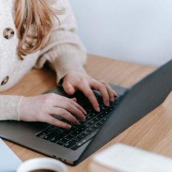 Best Sites for finding grants for bloggers. Photo of hands typing.